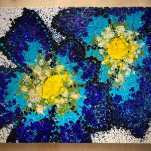 abstract painting of two flowers that are blue green and yellow and looks like splatter paint