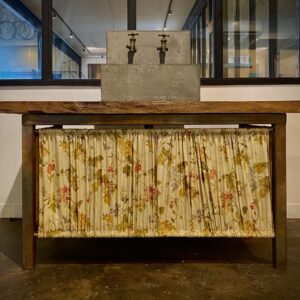 Concrete functioning sink attached to decorative wooden floral table